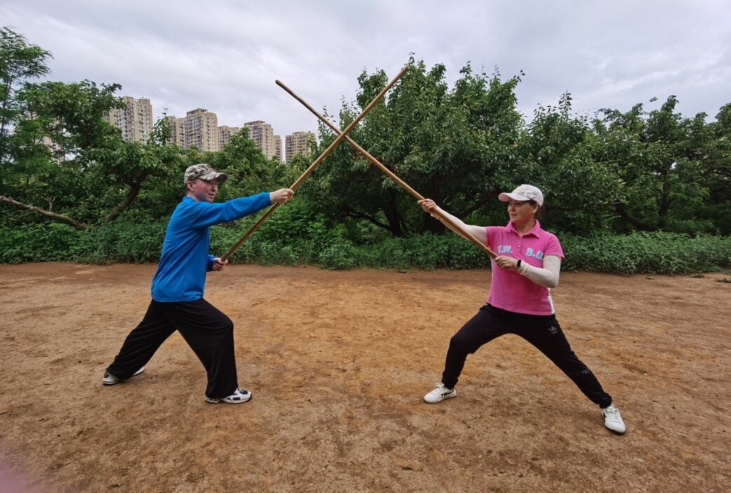 冯先生和张女士夫妻一起练习少林棍